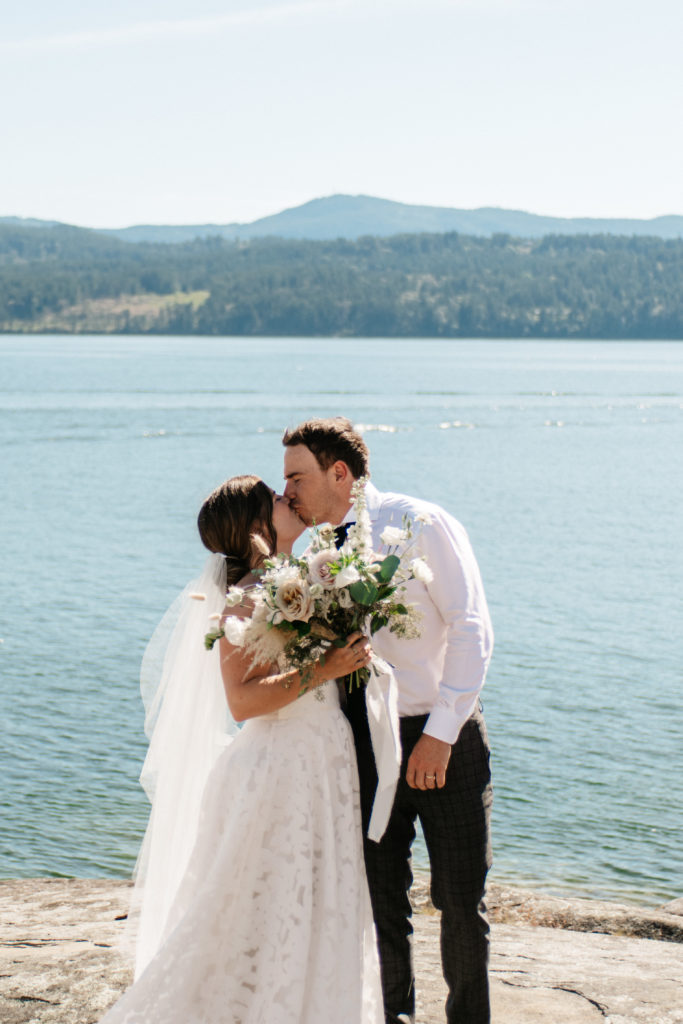 A couple with bouquet at their elopement on Salt Spring Island